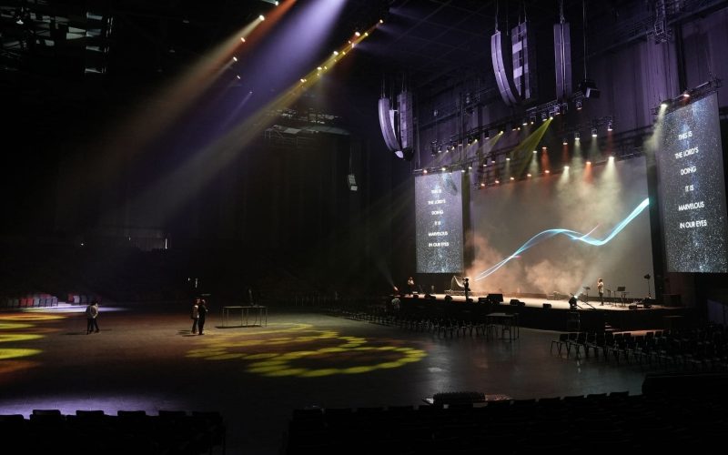 Close-up of the L-Acoustics L2 line array system flown 60 feet above the stage, seamlessly integrated into the ceiling architecture.