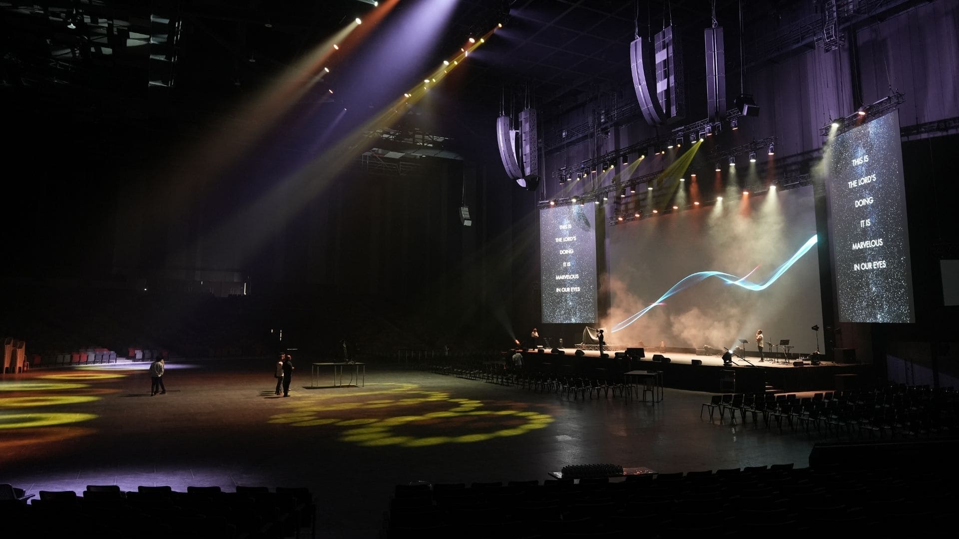 Close-up of the L-Acoustics L2 line array system flown 60 feet above the stage, seamlessly integrated into the ceiling architecture.