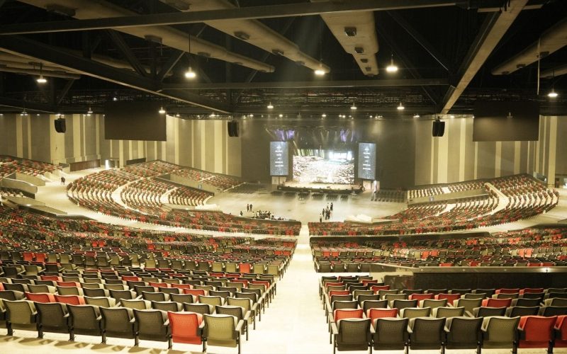 Wide-angle view of the semicircular 25,000-seat New Life Worship Centre auditorium in Chennai showing the massive scale and pillar-less design.