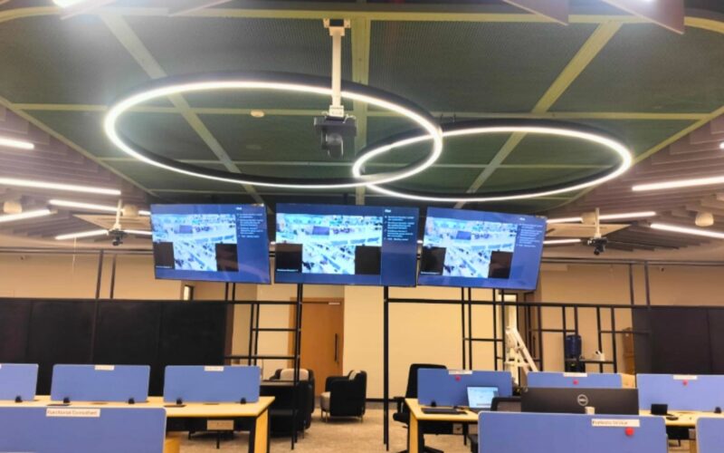 Professional Town Hall AV installation featuring QSC Core 110f DSP and enterprise conferencing infrastructure.