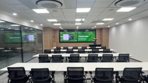Modern Syngenta meeting room featuring Zoom Rooms, Logitech Rally conferencing system, and Samsung professional display.