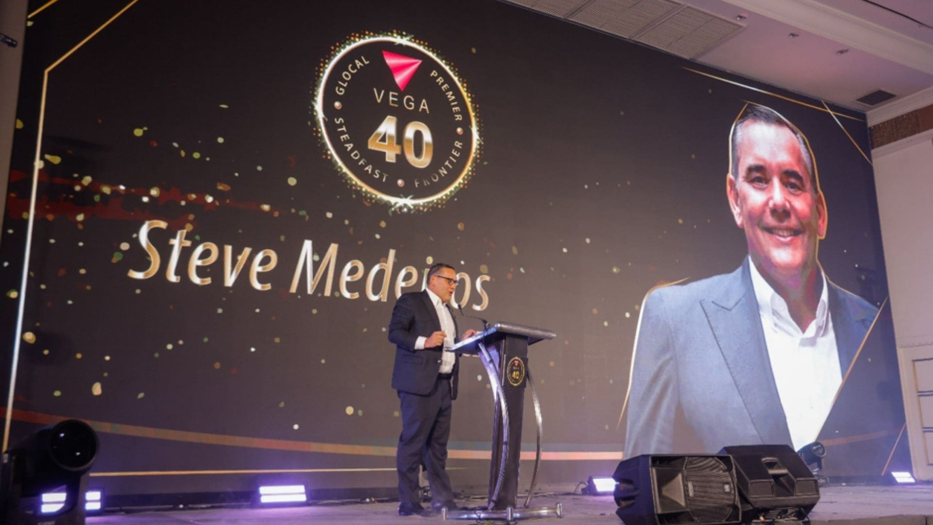 Blessing Joseph presenting VEGA's business expansion across India, the Middle East, and Africa during the anniversary event.