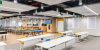 The executive boardroom at Grid Dynamics equipped with distributed ceiling speakers and professional wireless microphones.